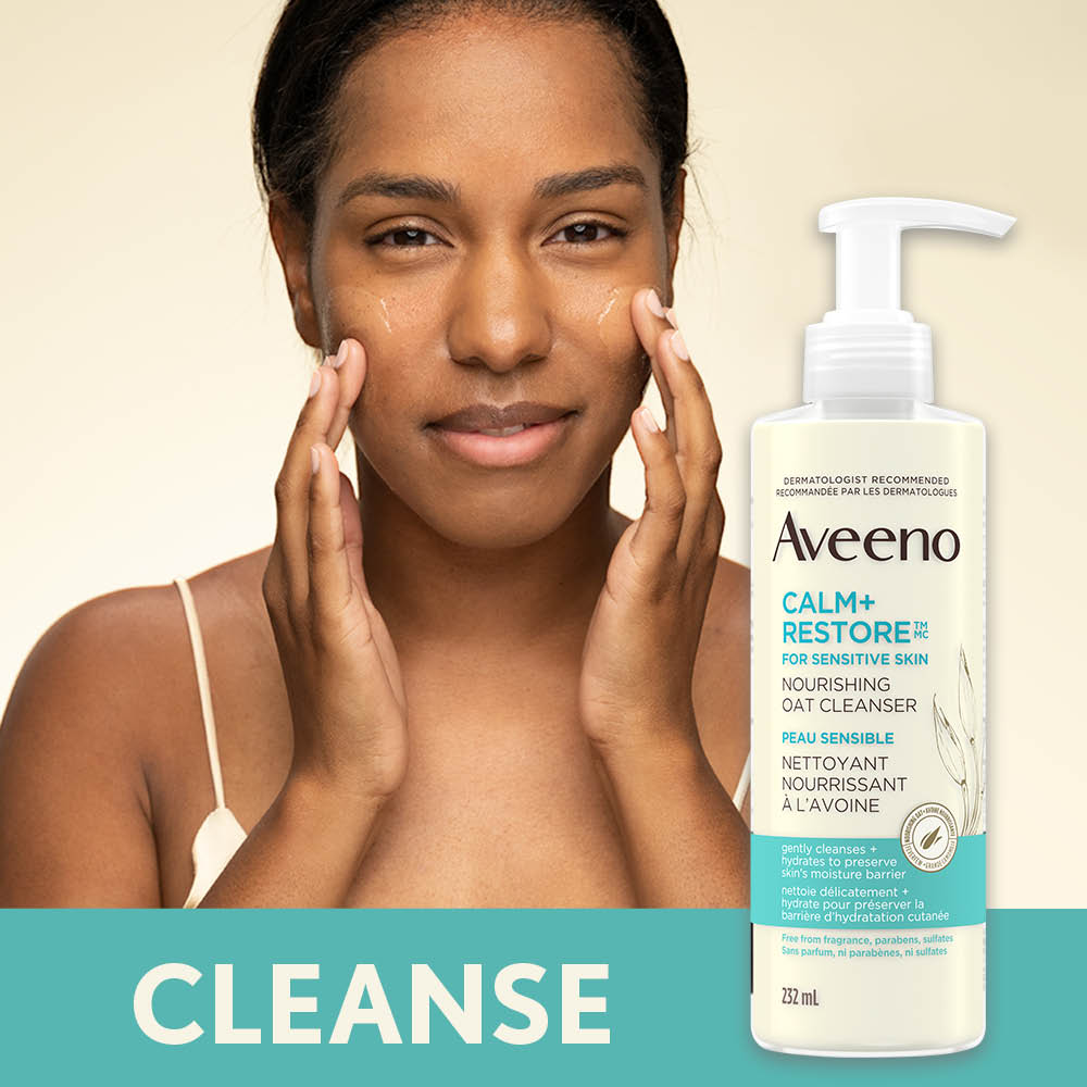 Woman Using AVEENO® Calm + Restore Sensitive Skin Oat Cleanser
