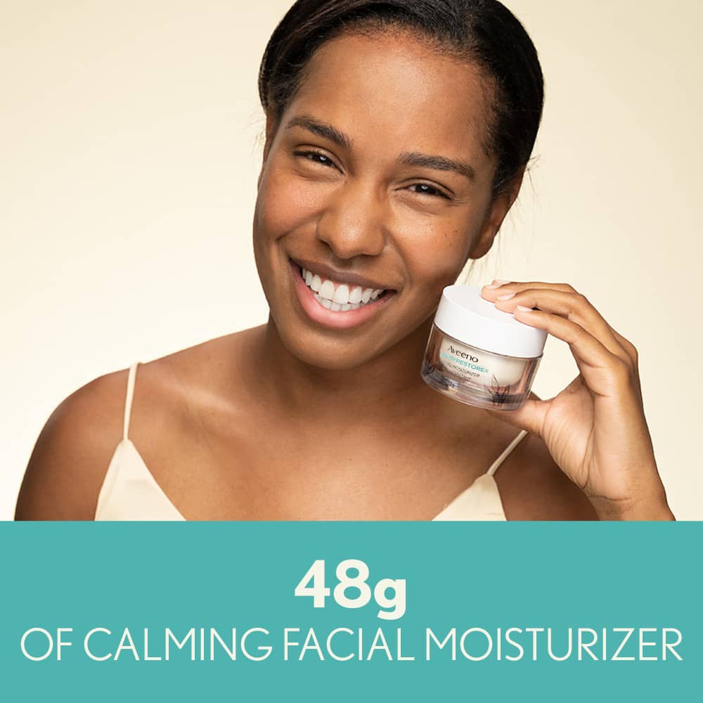 Woman Holding AVEENO® Calm + Restore Sensitive Skin Oat Gel Moisturizer 48g of Calming Facial Moisturizer