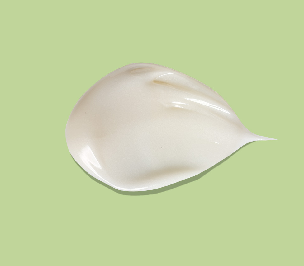 smear of lotion against a green background
